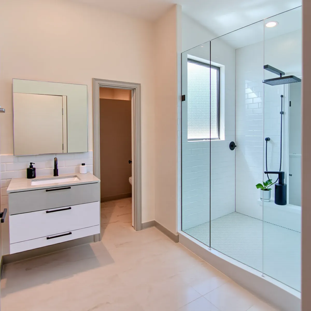 Renovated Torrance, CA small bathroom with marble countertops, glass shower, subway tiles, LED mirror, and natural light.