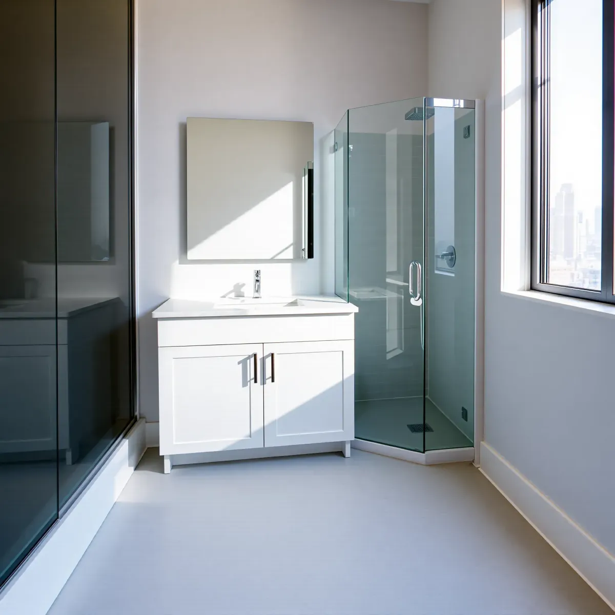 Renovated small Los Angeles bathroom with modern fixtures, marble countertop, glass shower, subway tiles, and city views.