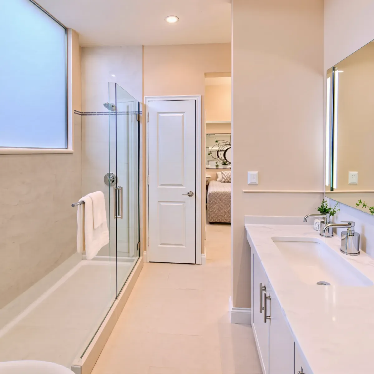 Beautiful renovated small bathroom in South LA featuring modern fixtures, frameless shower, neutral tones, and elegant decor.