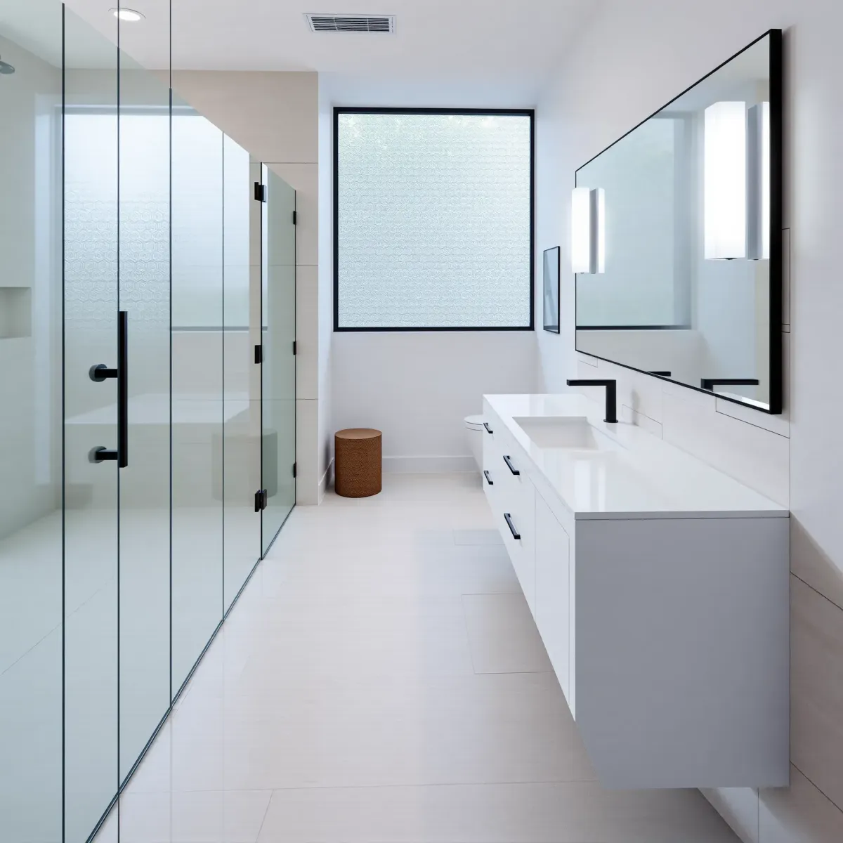 Modern Playa Vista bathroom with marble counters, glass shower, sleek fixtures, natural light, and elegant decor.