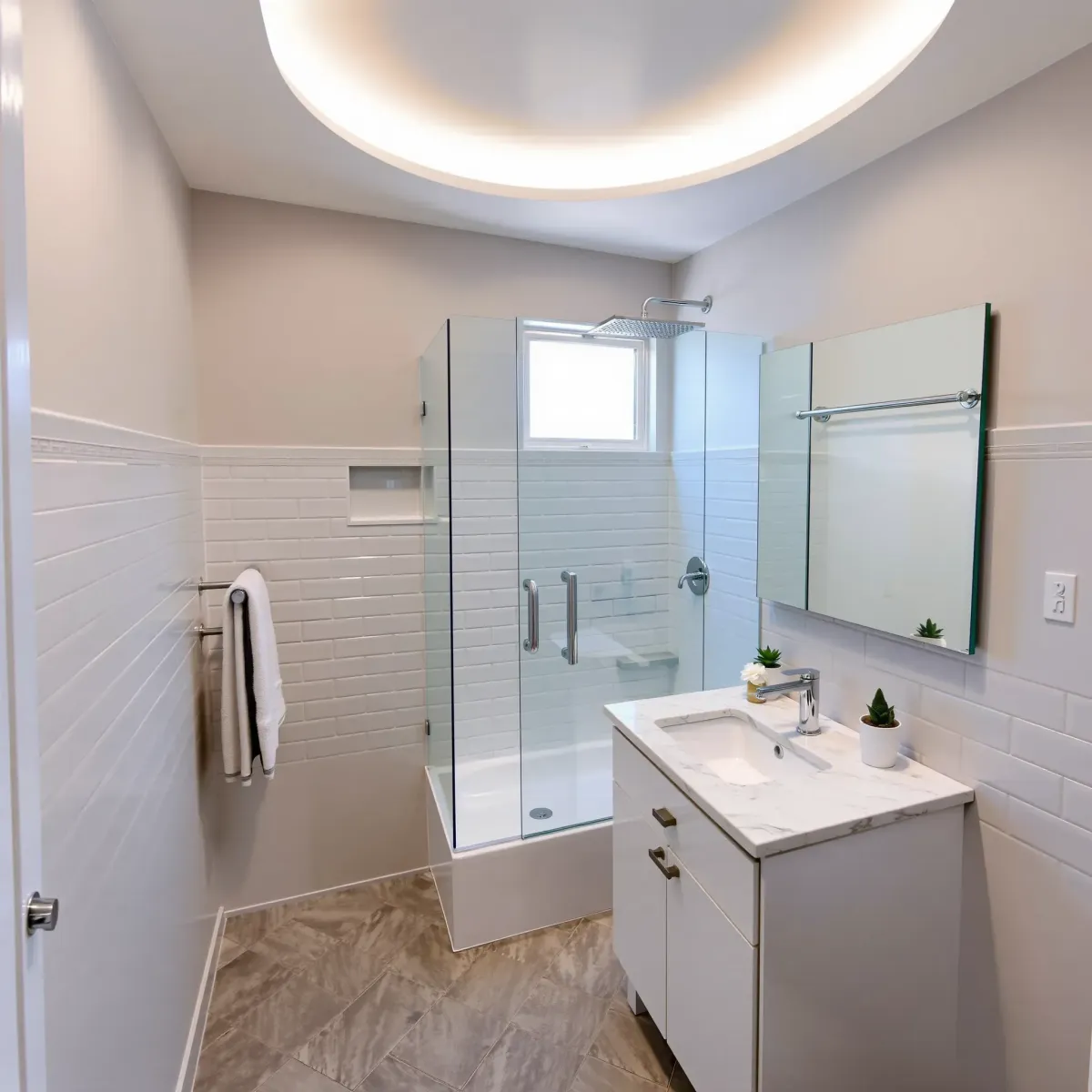 Modern small West Adams bathroom with taupe walls, white subway tiles, herringbone floor, marble vanity, and rainfall shower.