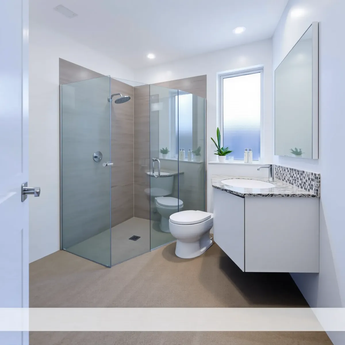 Renovated small bathroom in View Park, CA, with modern white vanity, mosaic tiles, frameless shower, and natural light.