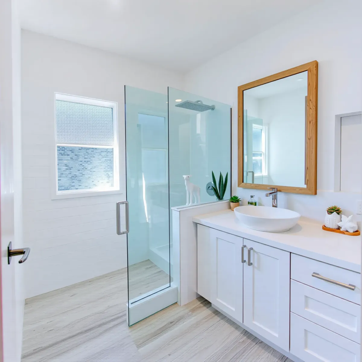 Renovated small bathroom in Torrance, CA featuring white subway tile, gray quartz countertops, walk-in shower, and modern fixtures.