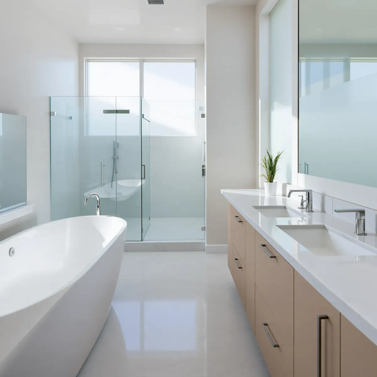 Renovated Mid Wilshire bathroom featuring a glass shower, freestanding tub, modern vanity, marble floors, and natural light.