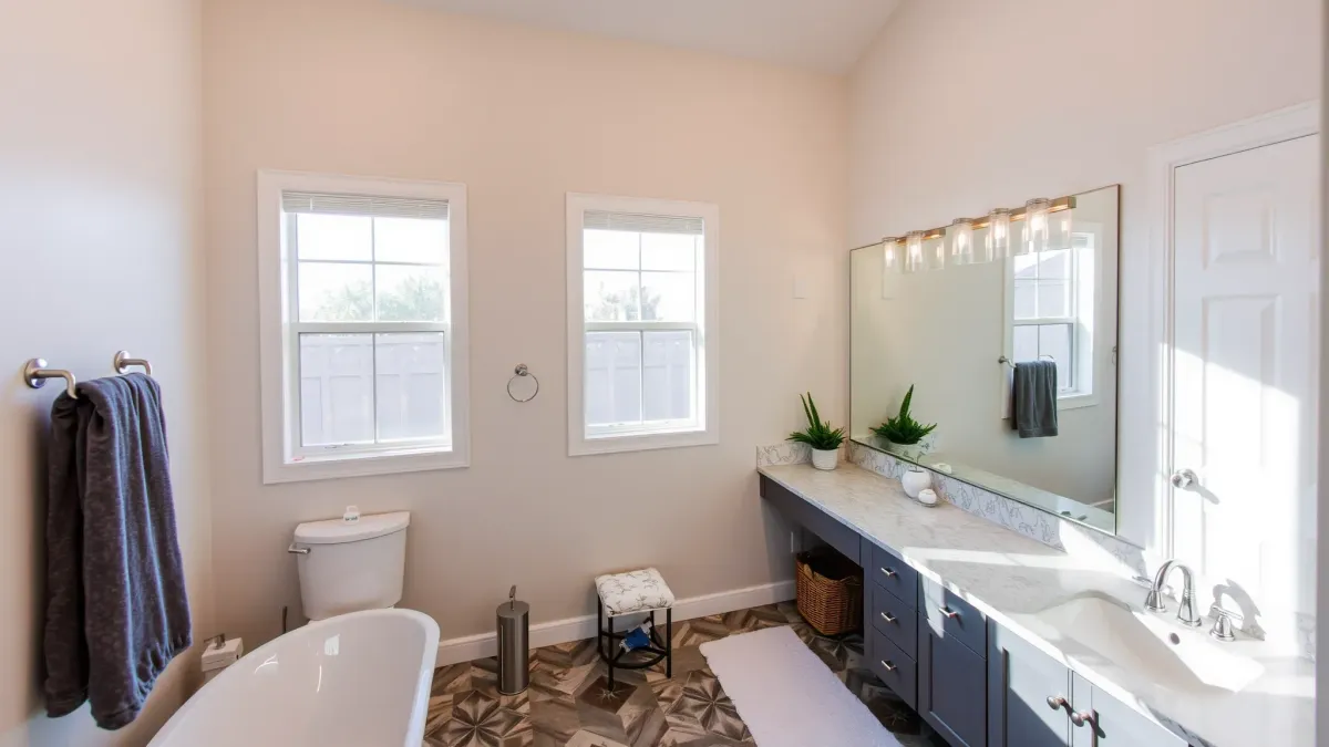 Beautiful modern bathroom in Gardena, CA with marble tub, walk-in shower, double vanity, and polished finishes.