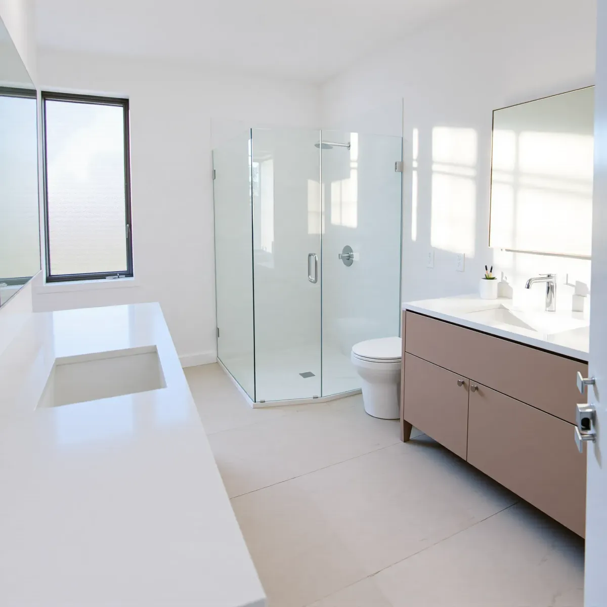 Remodeled small bathroom in Hyde Park, CA with quartz countertops, glass shower, vessel sink, marble tiles, and natural light.