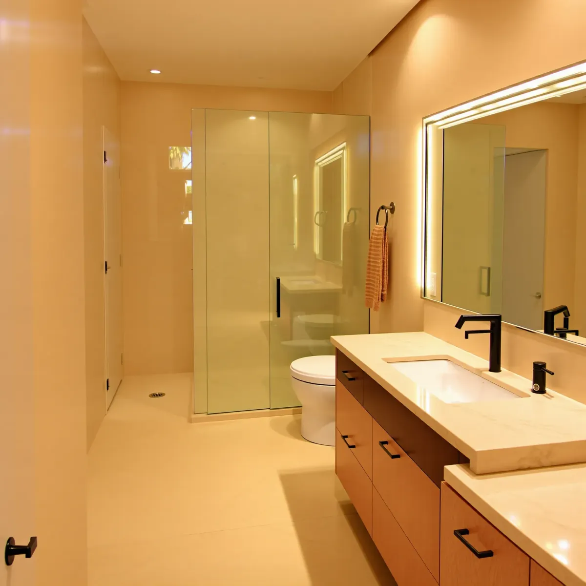 Elegant Beverly Hills bathroom with marble countertops, walk-in shower, soaking tub, neutral tiles, and natural light.