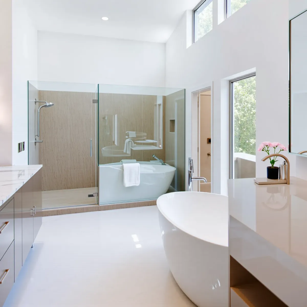 Renovated Rancho Park bathroom with modern fixtures, marble countertops, walk-in shower, soaking tub, and elegant decor.