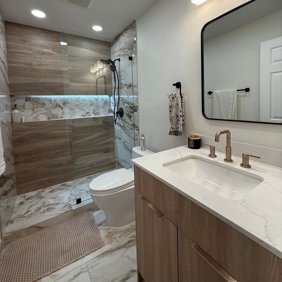 Modern bathroom remodel with floating vanity, marble-look tile shower, and LED accent lighting