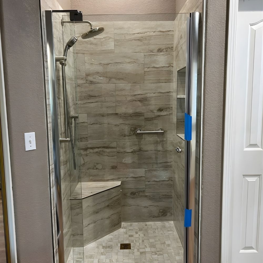 Tile shower installation with built-in bench, handheld showerhead, and slip-resistant flooring