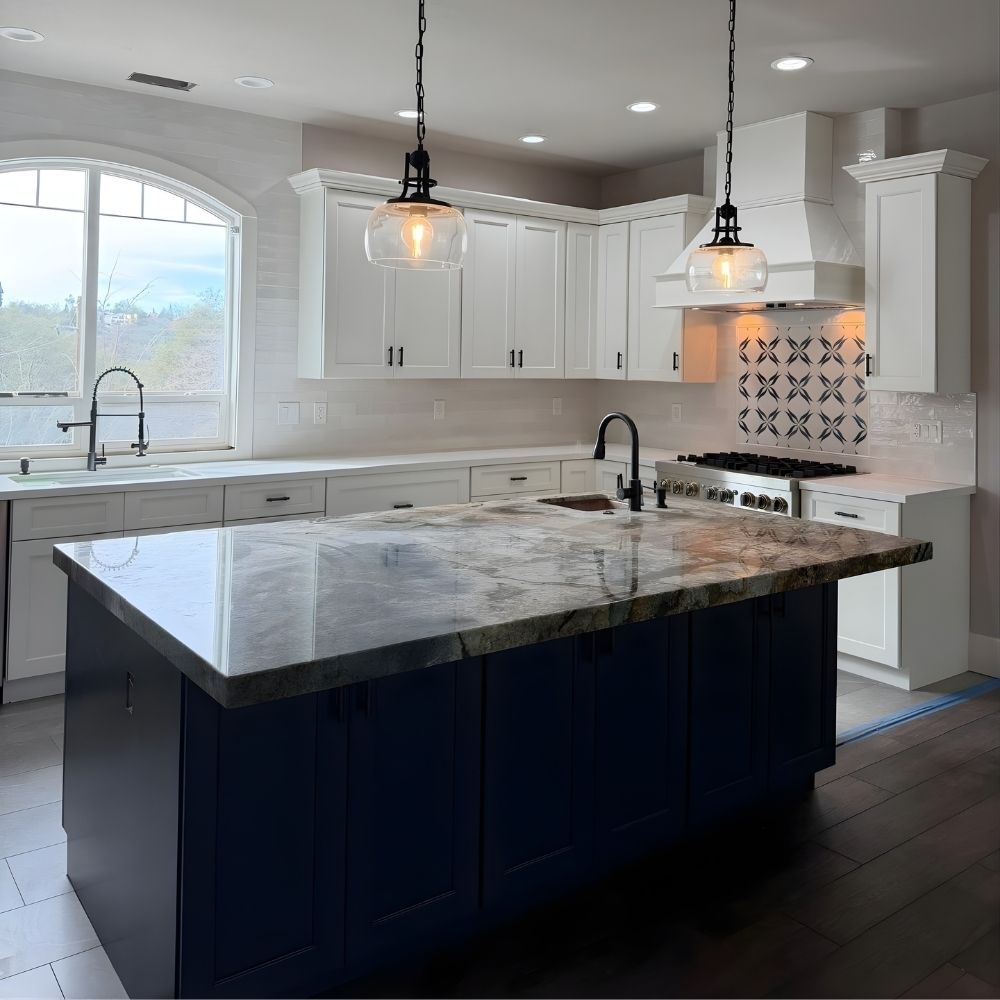 Kitchen island with stone countertop, hardwood flooring, tiled backsplash, and pendant lights