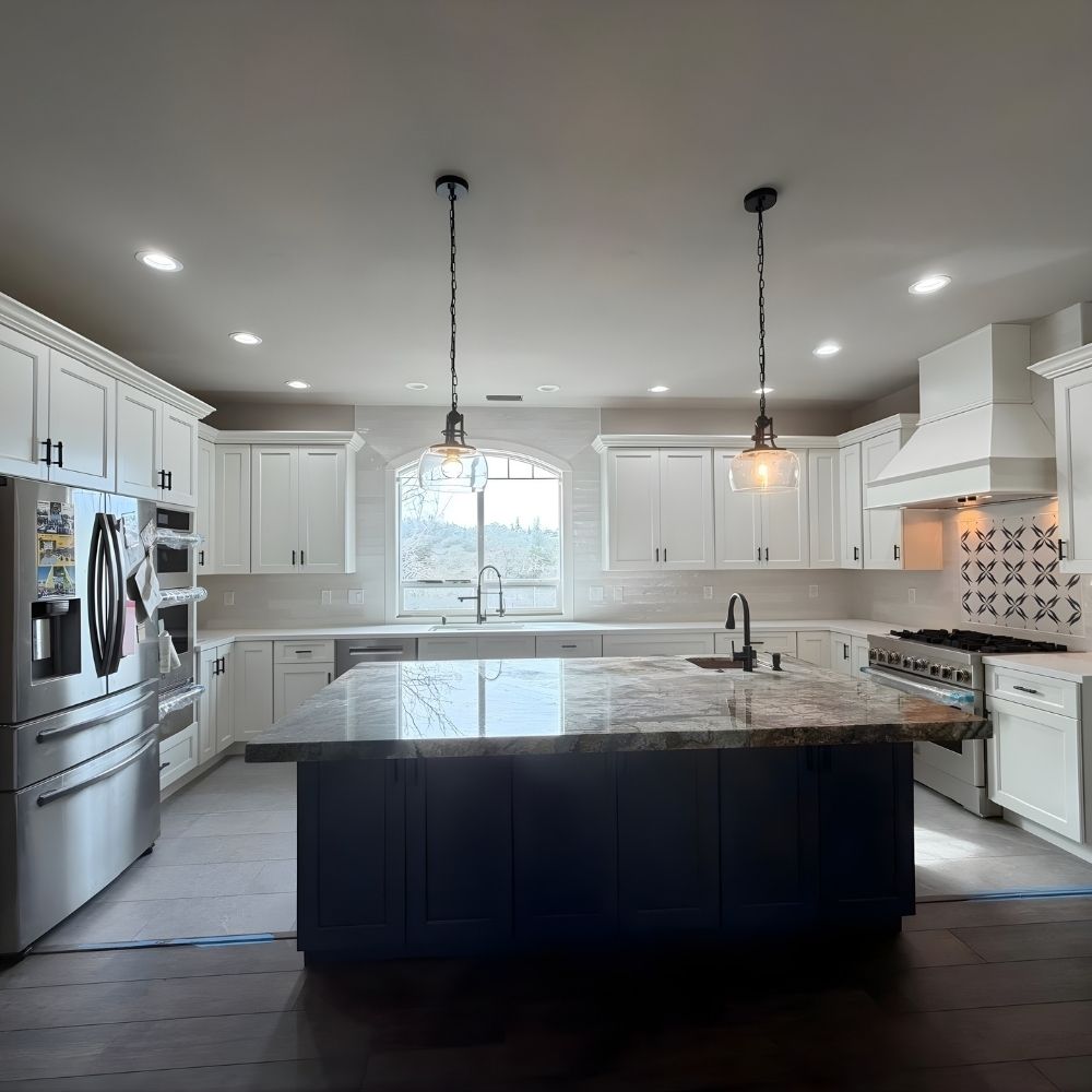 Kitchen with professionally installed stainless steel refrigerator, range, and built-in appliances