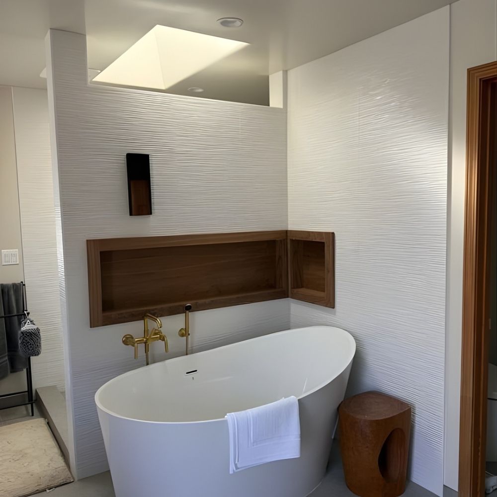 Luxury bathroom featuring freestanding soaking tub, textured wall panels, and recessed lighting