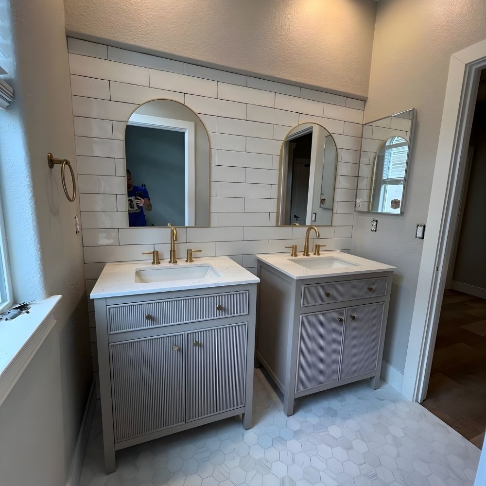 Bathroom vanity update with subway tile backsplash, arched mirrors, and hex tile flooring
