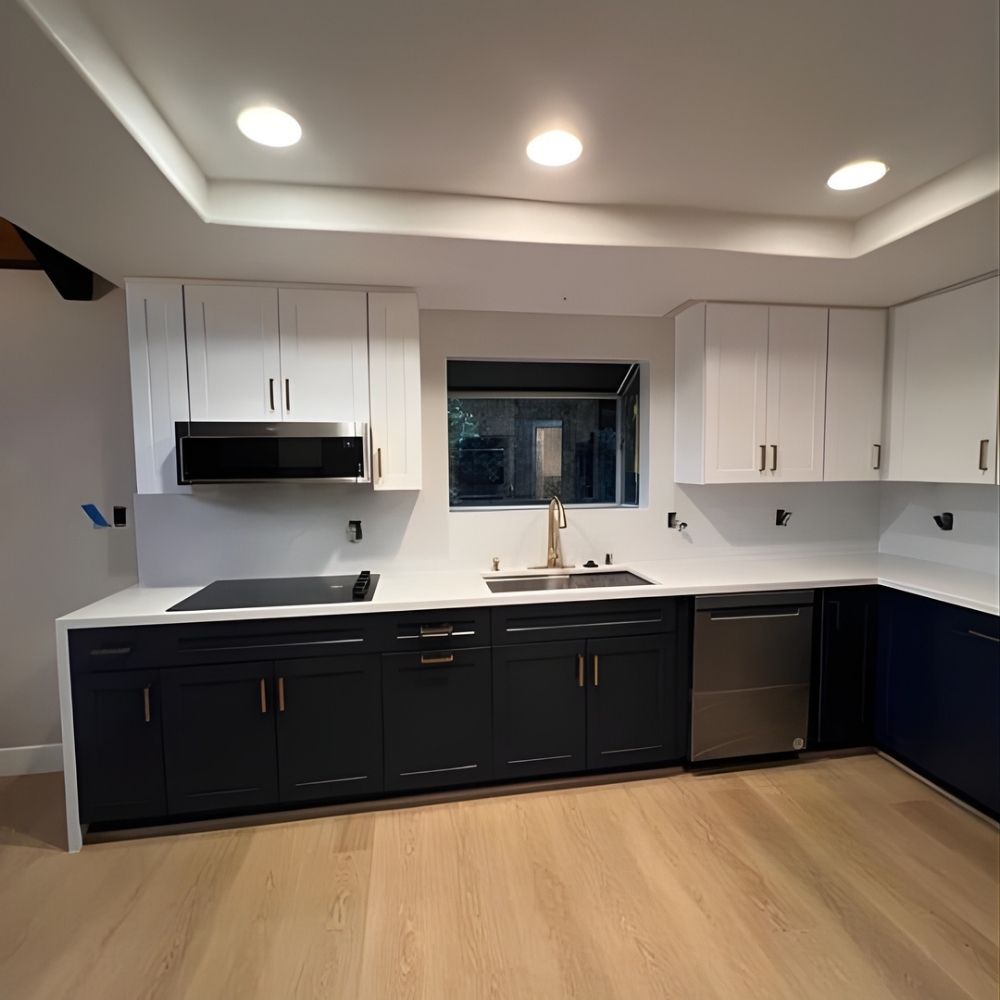 Modern kitchen with wood flooring, tiled walls, recessed ceiling lights, and two-tone cabinetry