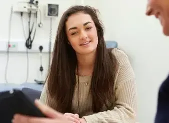 A healthcare professional in a Sydney medical practice discussing efficiency gains from a Managed Print Plan.