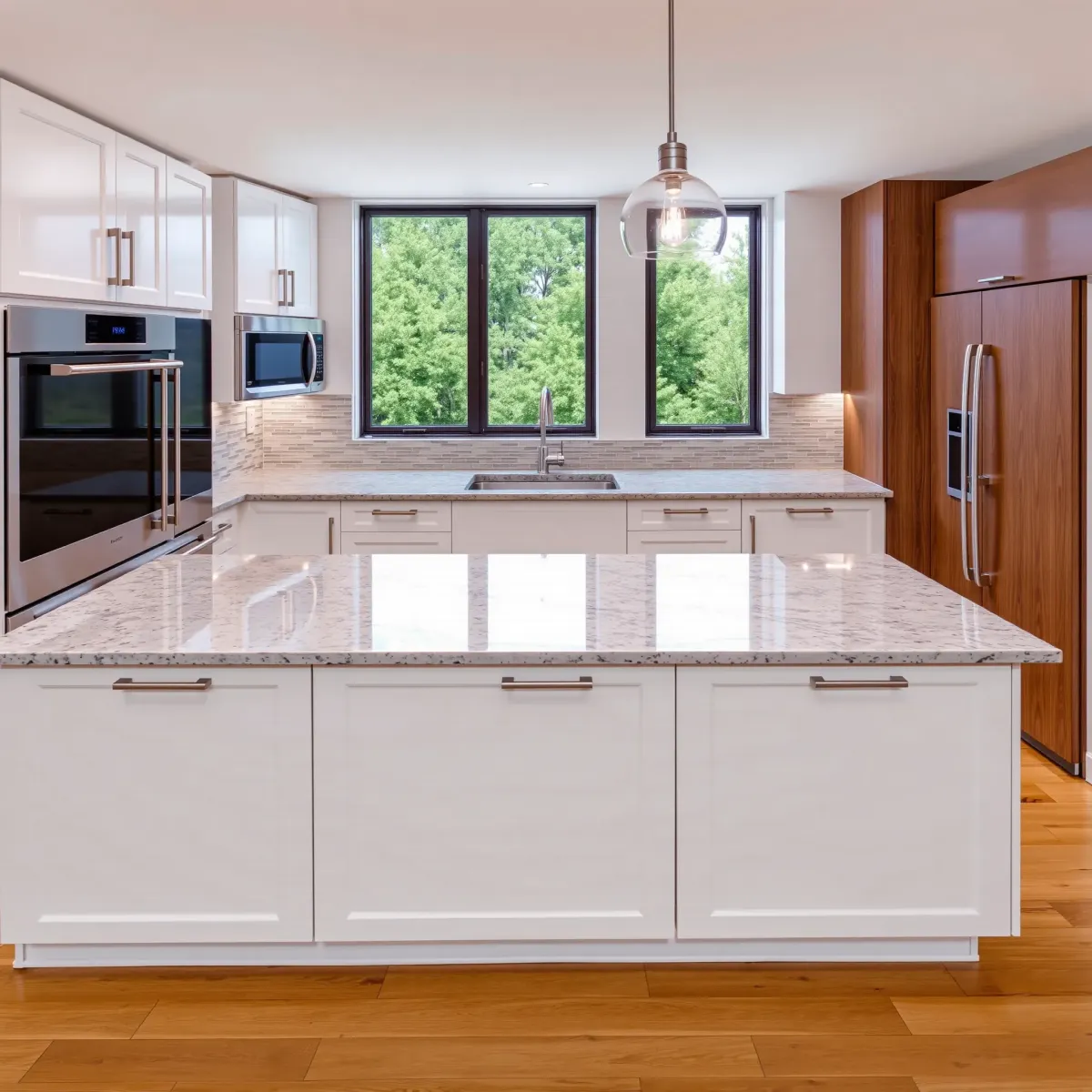 Beautiful renovated kitchen in Sweetwater, TN with granite countertops, stainless appliances, wooden cabinets, and hardwood floors.