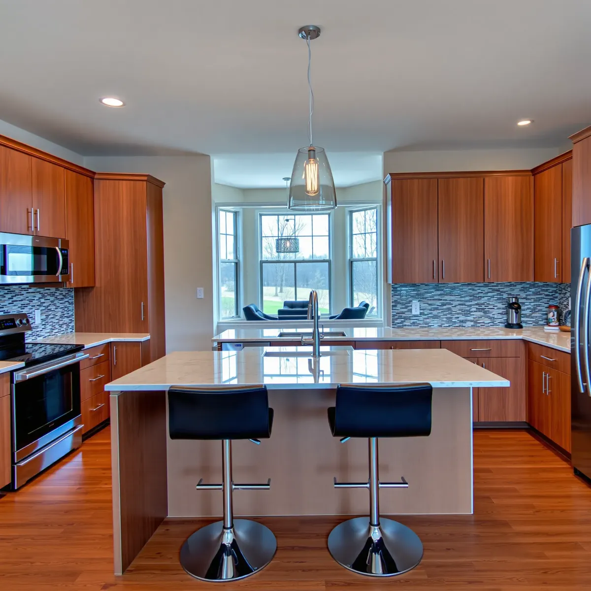Recently remodeled Lenoir City kitchen with sleek cabinetry, quartz countertops, stainless steel appliances, and warm hardwood floors.