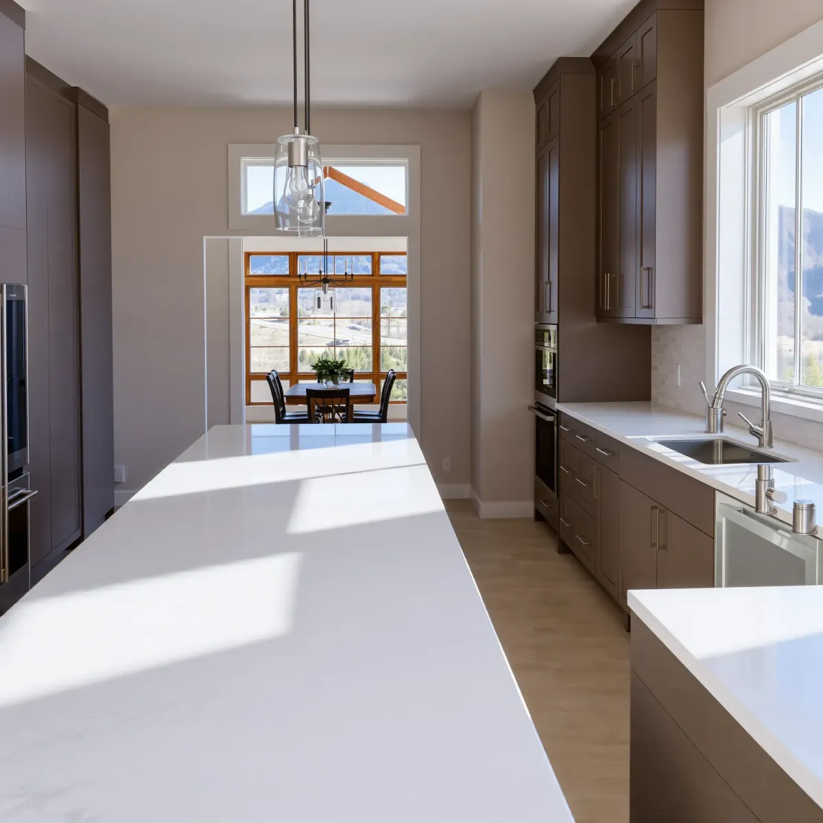 Remodeled Johnson City kitchen with modern cabinets, quartz countertops, a marble island, stainless appliances, and mountain views.