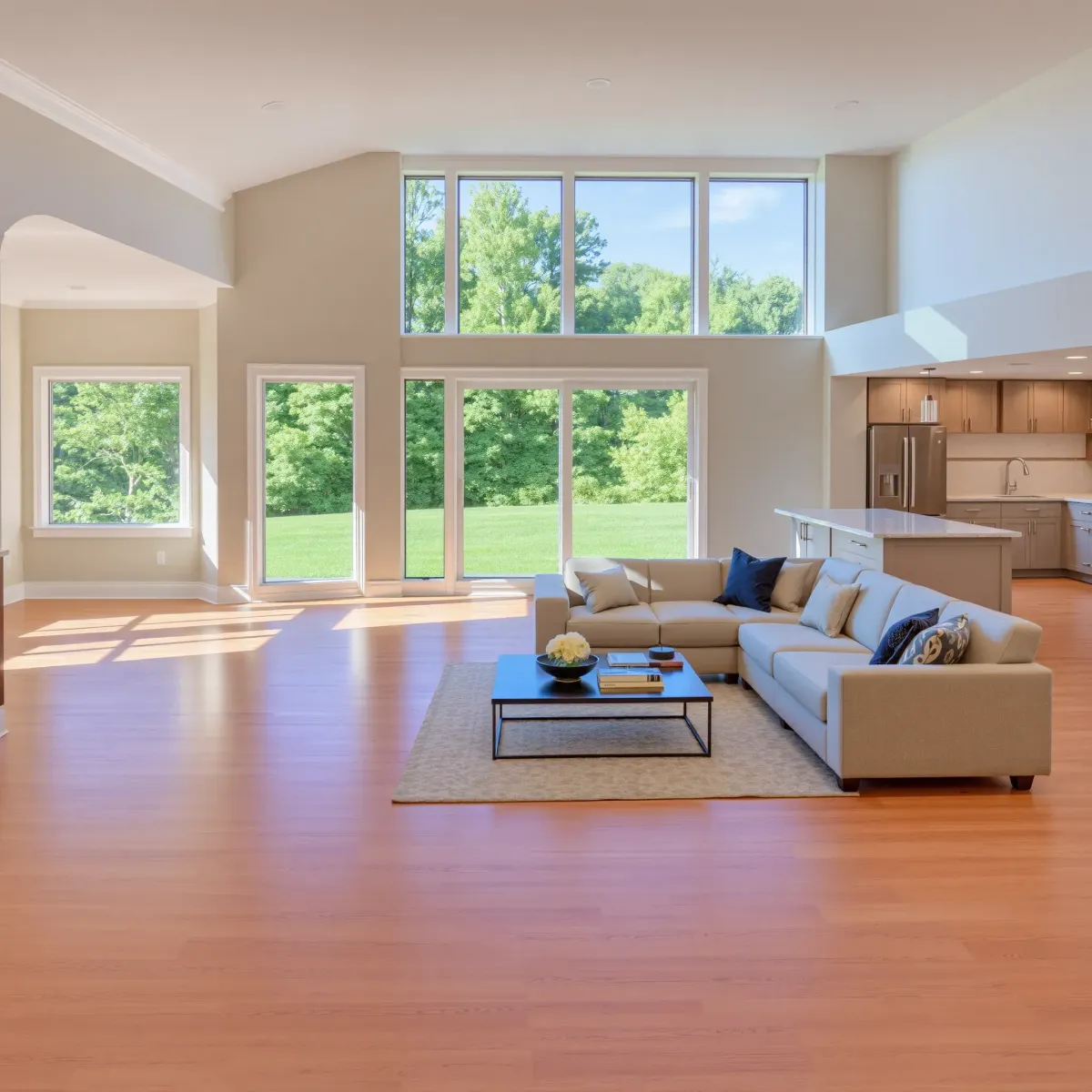 Modern renovated living room in Jefferson City, TN with hardwood floors, contemporary furniture, large windows, and a stone fireplace.