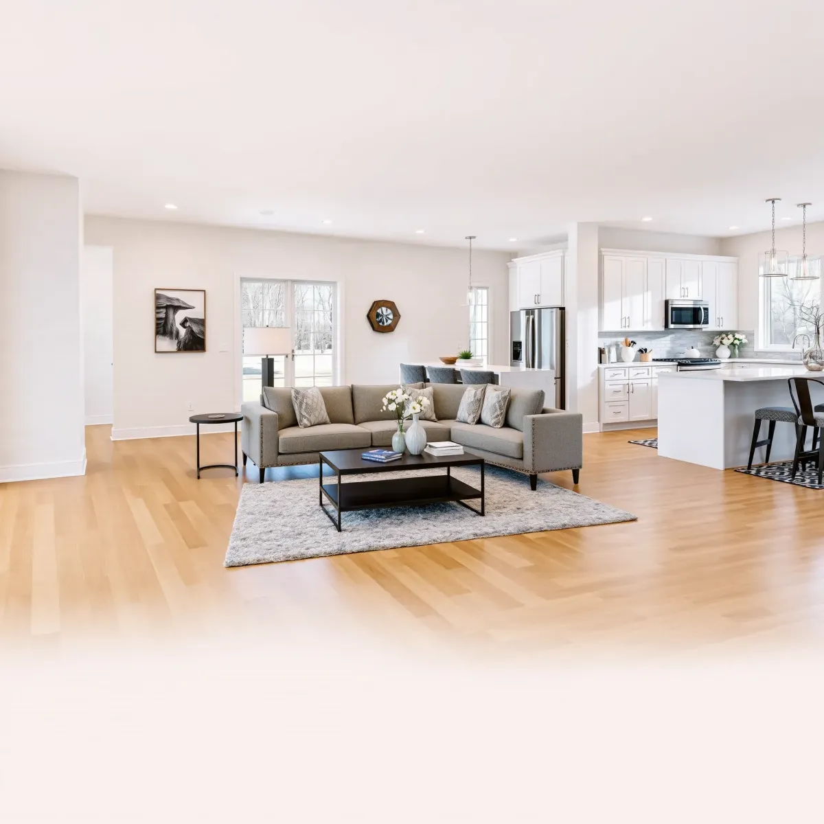 Completed home remodel in Clinton, TN: modern living room with hardwood floors, sleek fireplace, open-concept kitchen, and bright, stylish interior.