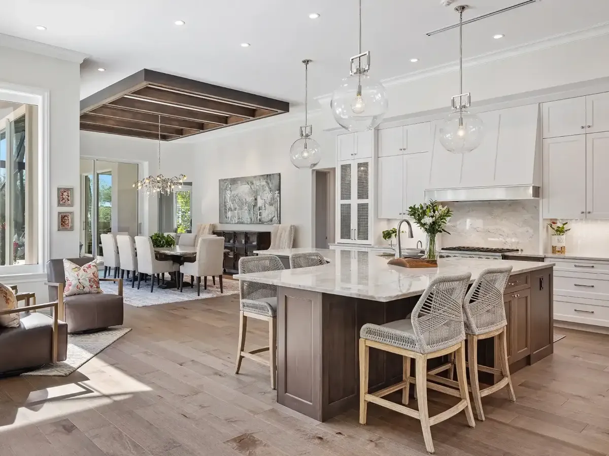 Modern Knoxville kitchen with wood cabinets, stainless steel appliances, granite island, pendant lighting, and lush backyard view.
