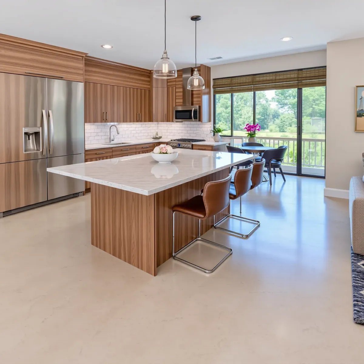 Modern Jefferson City kitchen remodel with stainless appliances, marble countertops, large island, and natural light.