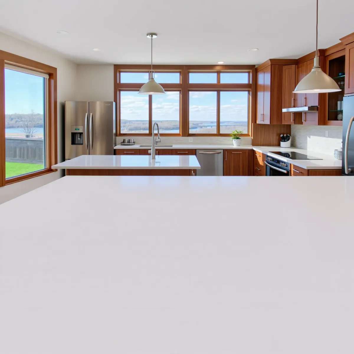 Modern Jefferson City kitchen with stainless appliances, granite counters, custom wood cabinetry, and natural daylight.