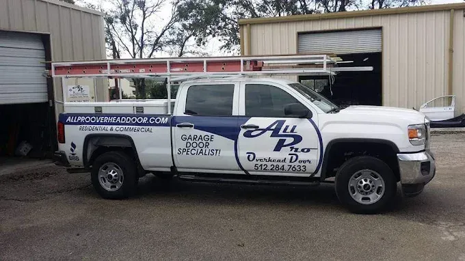 All Pro Overhead Door technician performing a safety inspection on a residential garage door