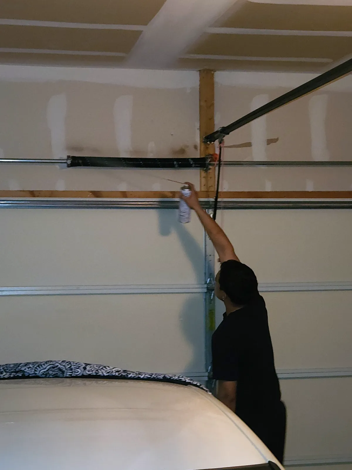 All Pro Overhead Door technician performing a safety inspection on a residential garage door