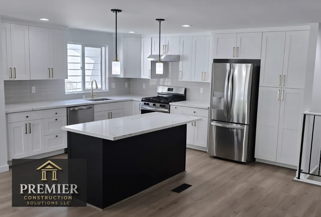 Mid-level kitchen remodel by Premier Construction Solutions with modern, clean look, eat in island and updated lighting and appliances.