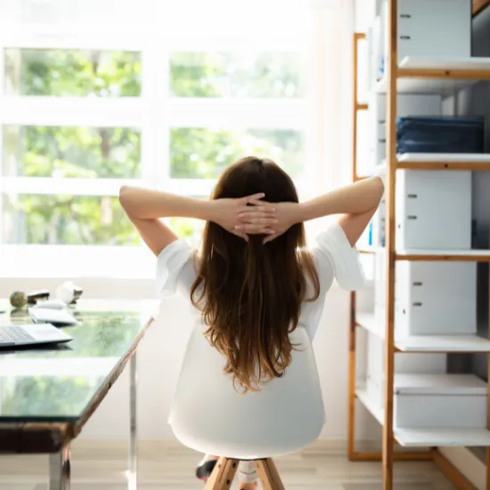 a woman relaxing while she works from home
