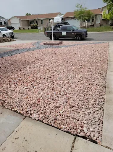 Professional softscape design featuring shrubs, flower beds, and decorative mulch in Utah residential yard