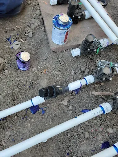 Howard and Family testing sprinkler heads in a backyard system