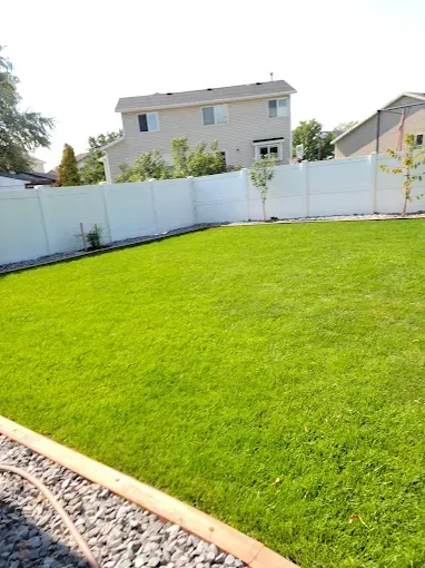 Howard and Family team mowing a front yard during routine weekly lawn care service