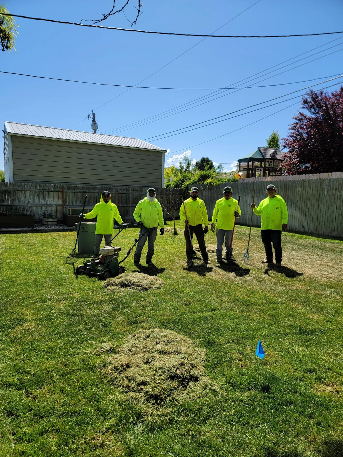 Howard & Family Lawn Services performing professional leaf removal in West Valley City yard