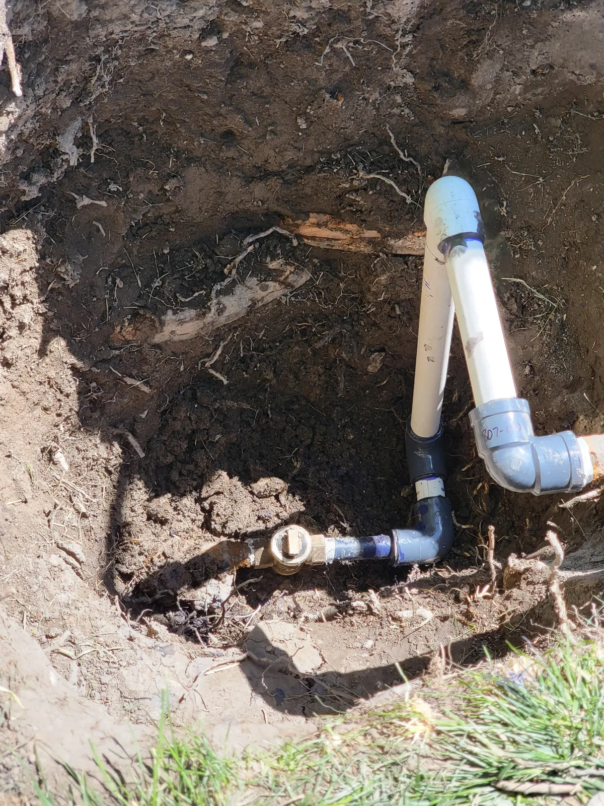 Howard and Family testing sprinkler heads in a backyard system