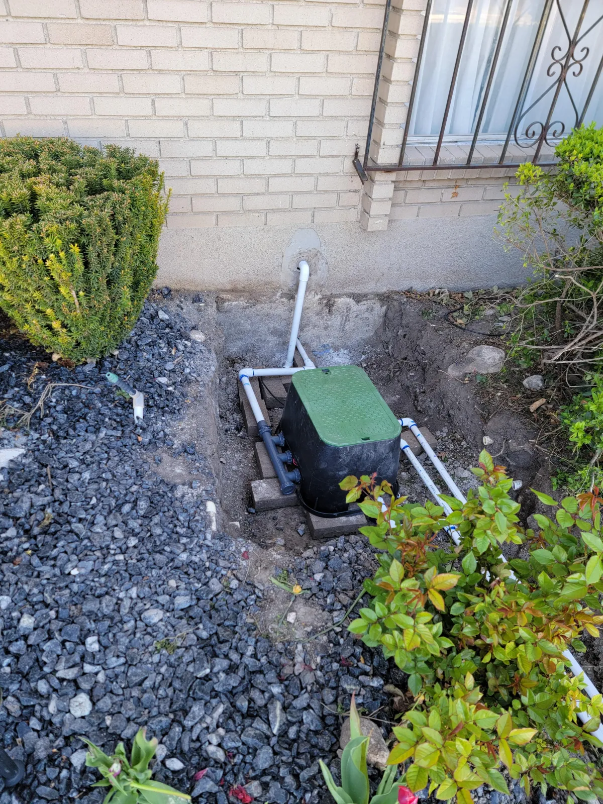 Automatic sprinkler system watering freshly sodded lawn