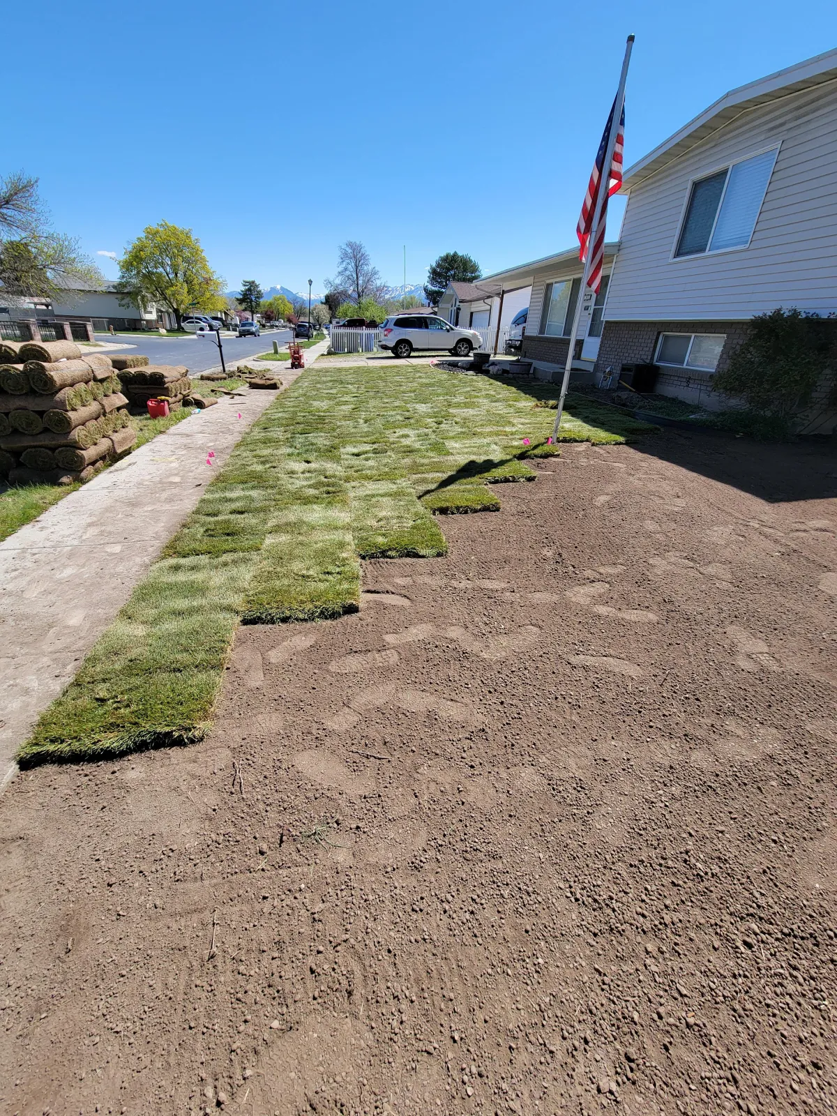 Howard & Family Lawn Services installing fresh sod in West Valley City backyard for lush, green lawn transformation