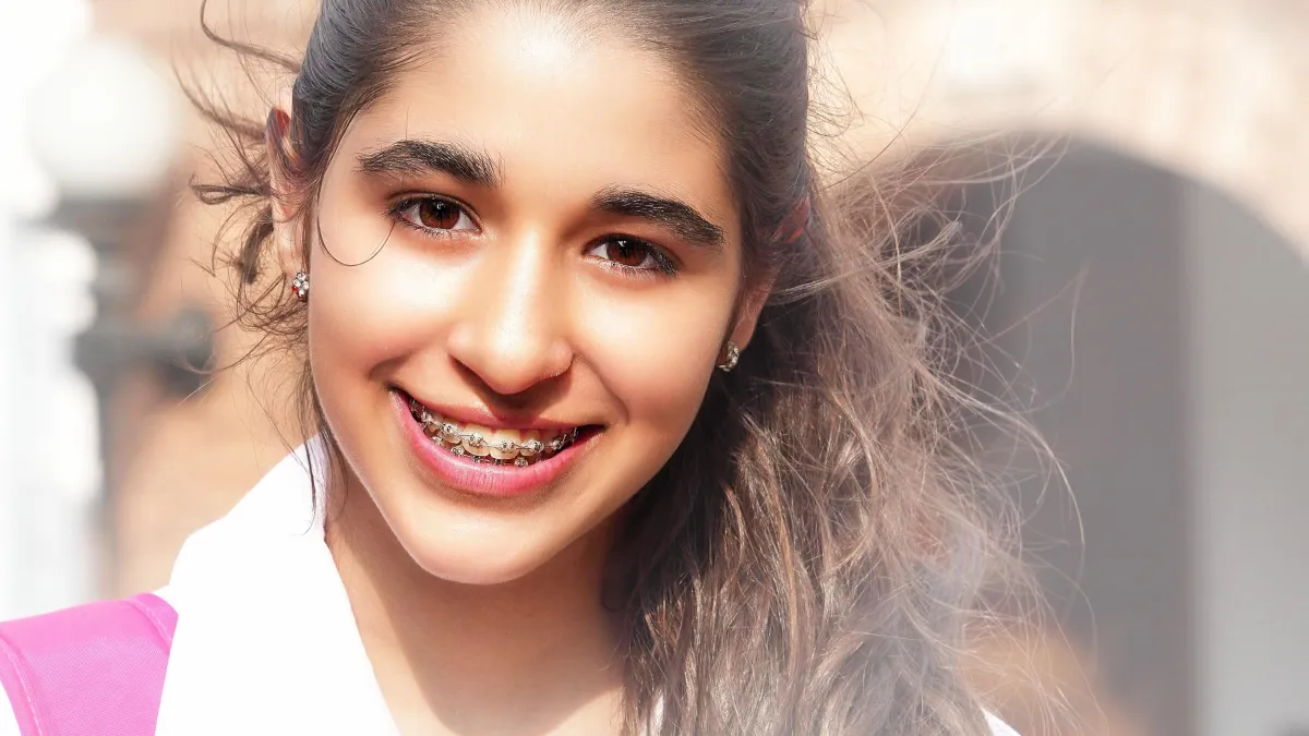 person with silver teeth braces