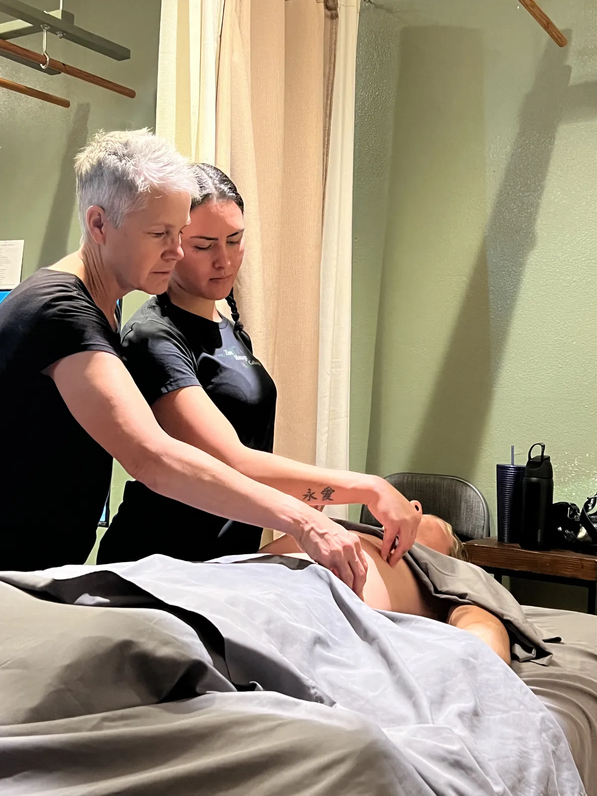 Karey Kosorok teaching a Manual Lymphatic Drainage abdominal technique to a student at Zion Massage College.