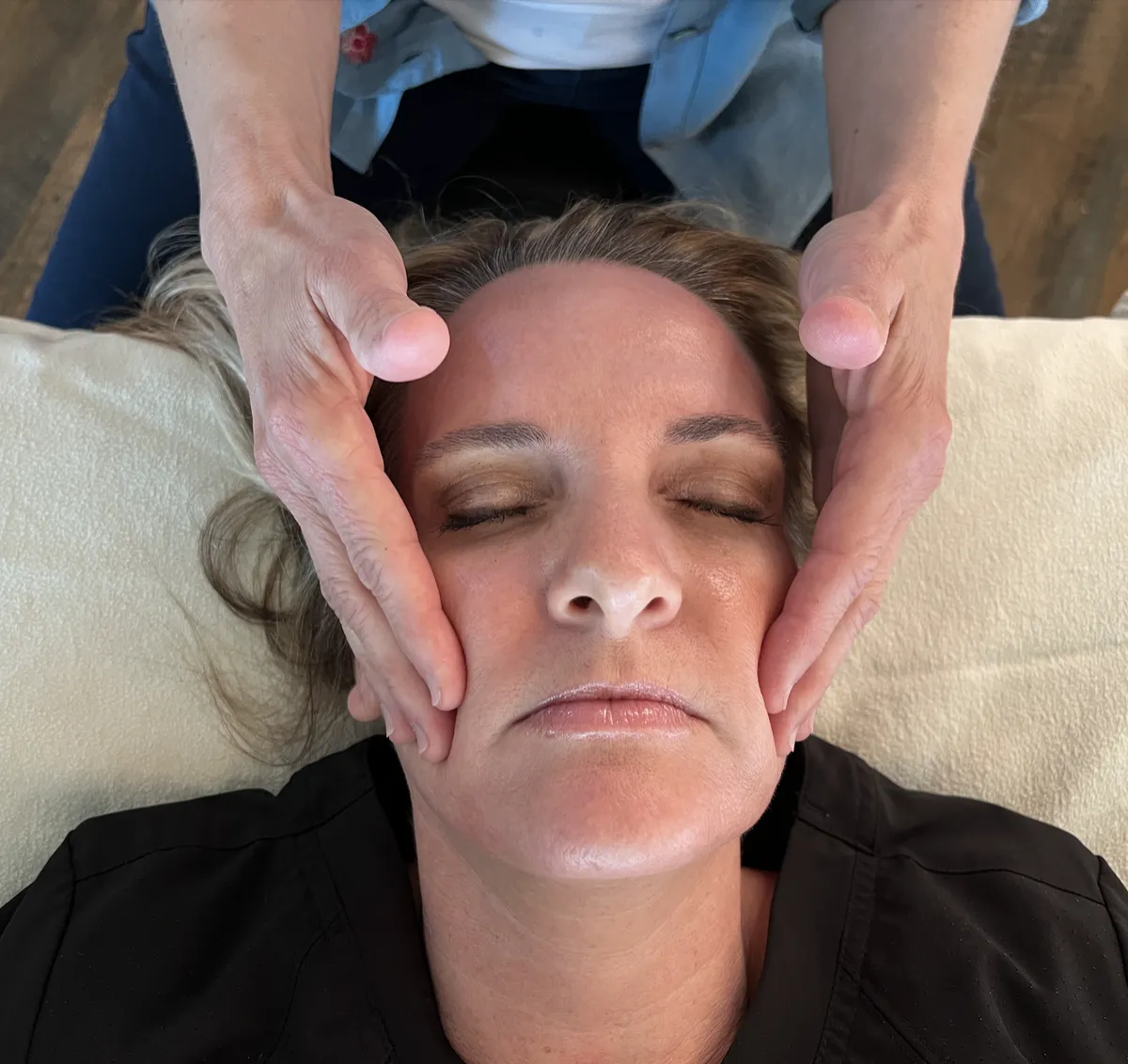 Close-up of a CranioSacral Therapy mandible release technique on a student.