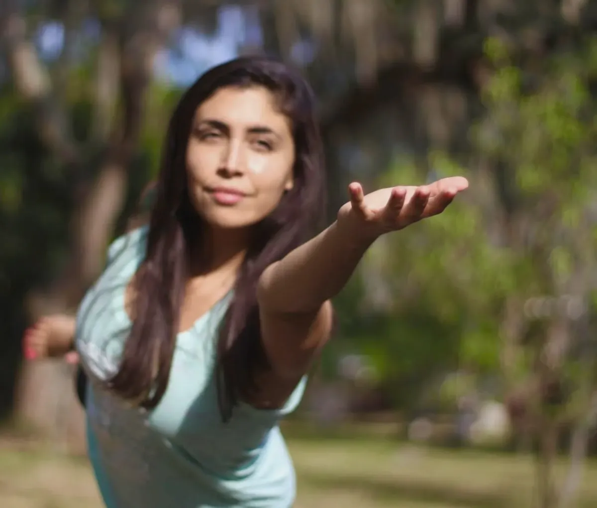 silhouette of woman raising her right hand