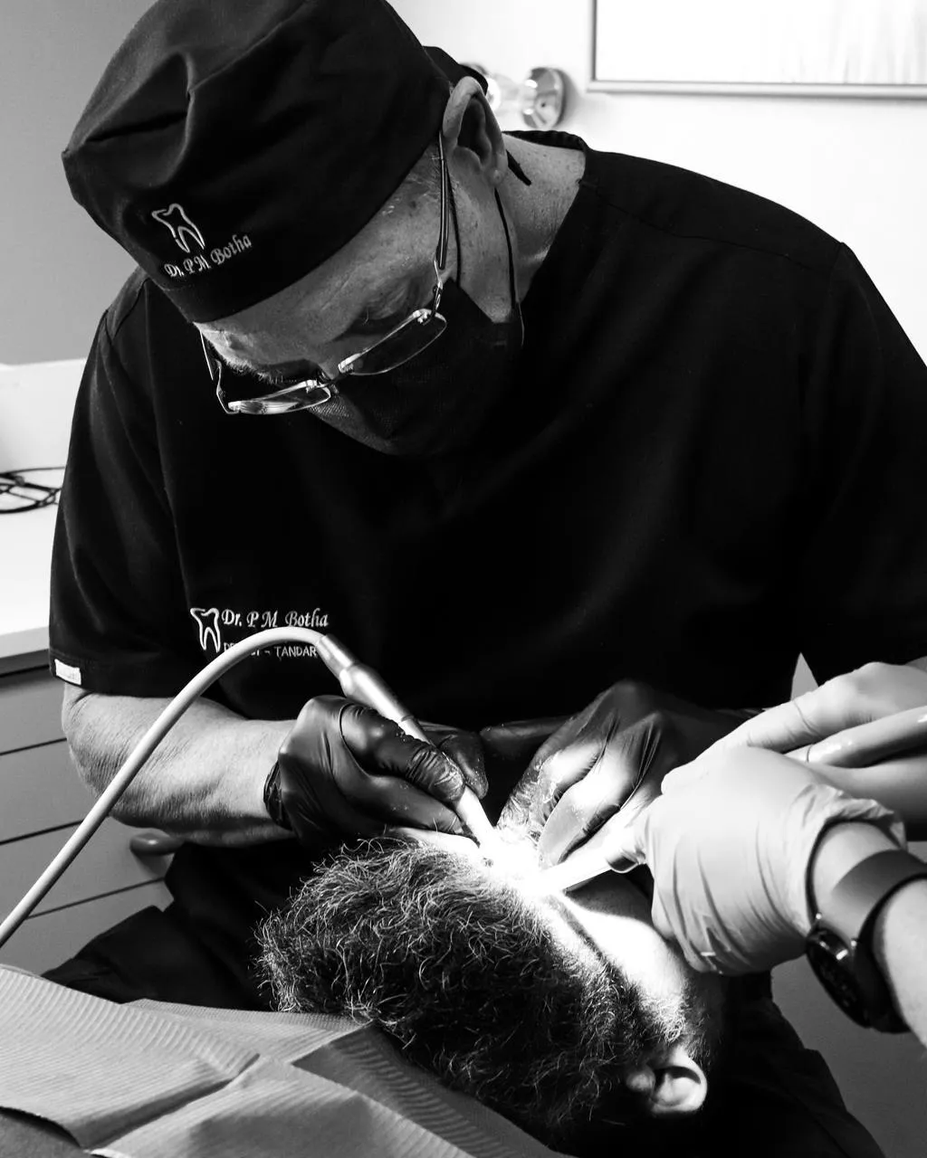 Dr PM Botha performing dental treatment on a patient at his Witbank clinic – expert care in aesthetic and general dentistry.