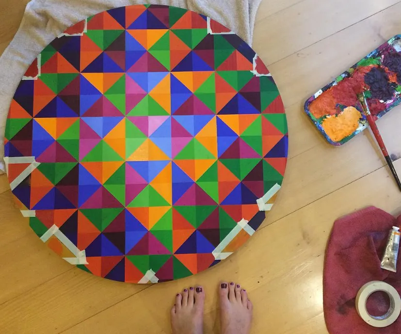 Creative coaching for artists by Lucy Melville – shown painting in her home studio