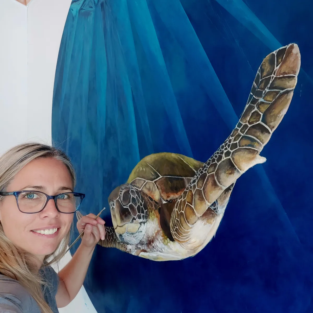 Artist Lucy Melville creating a new piece — learn how to confidently share and sell your art