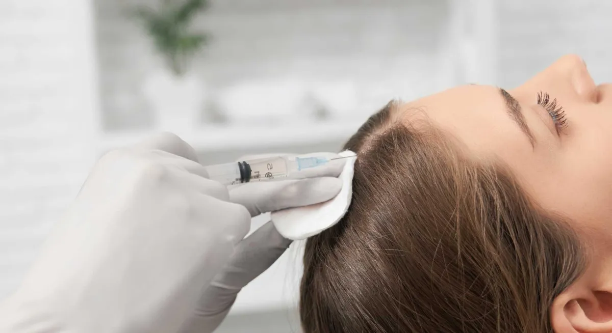 person holding dandelion flower