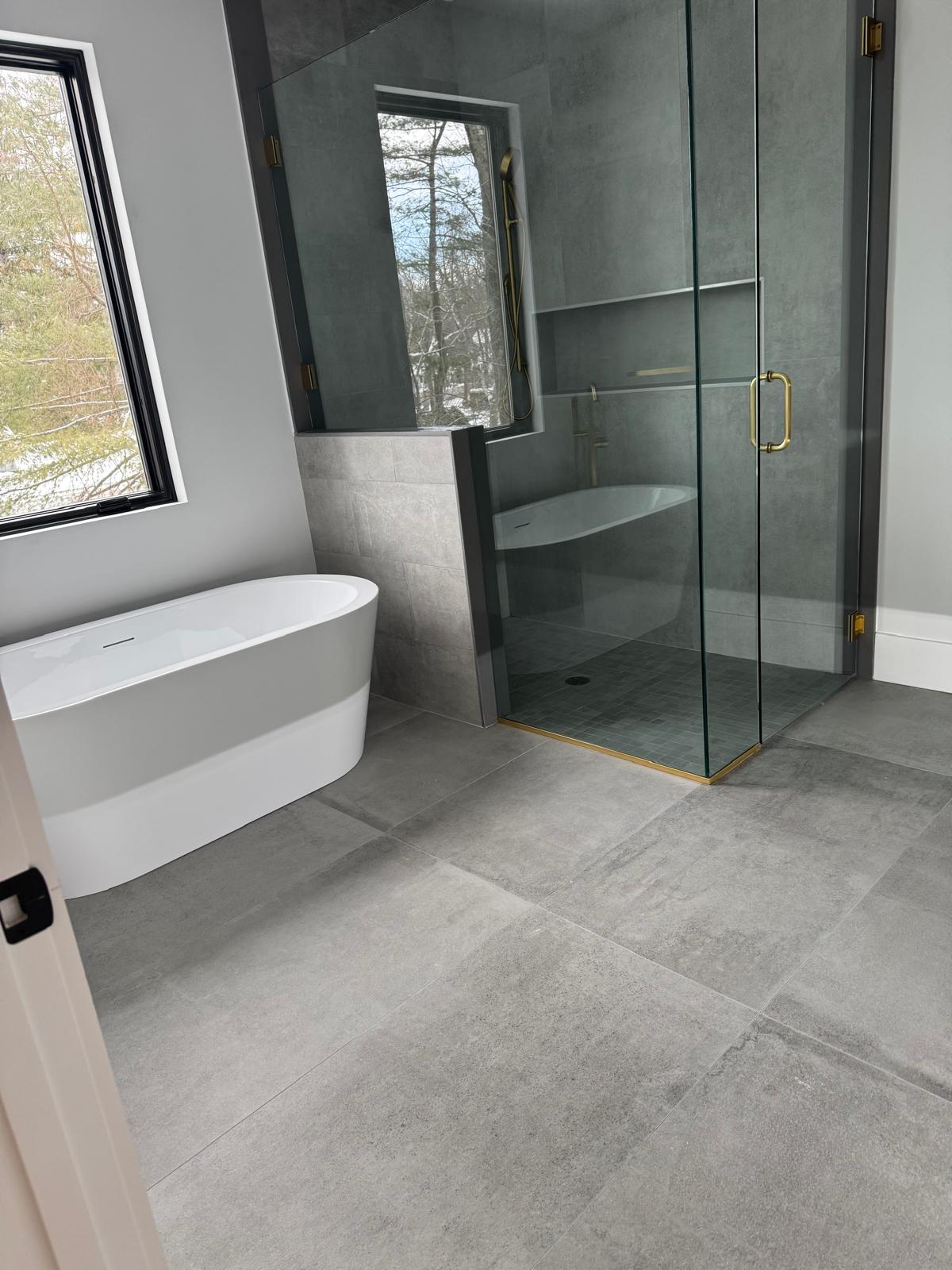 A bathroom with a bathtub and a large window