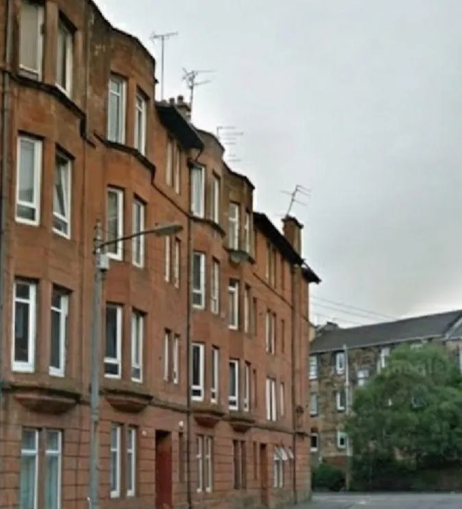 a kitchen with three stools and a center island