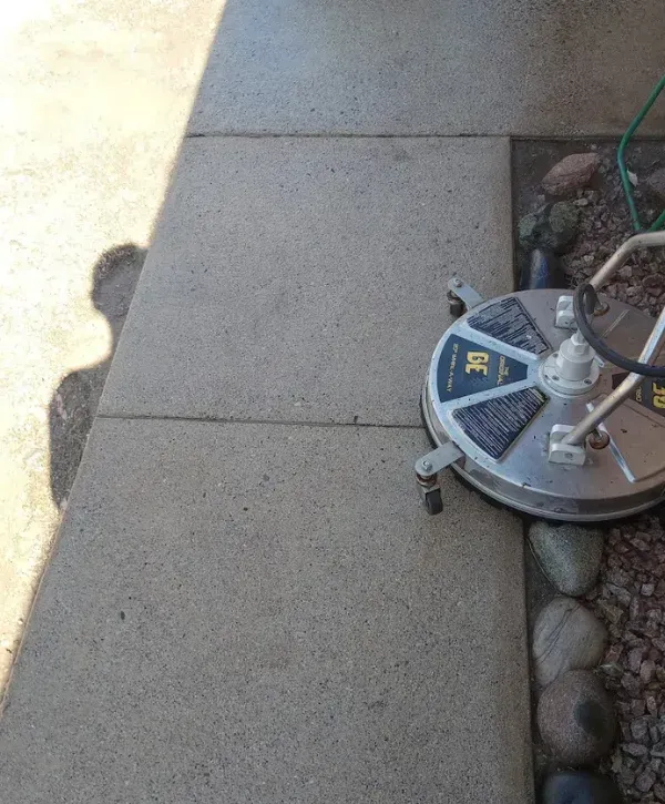 Freshly power-washed sidewalk showing before and after results